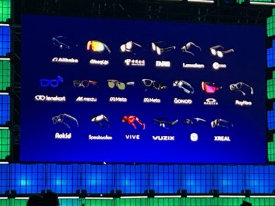 A slide from Qualcomm's presentation showing logos of various smart glasses and wearable companies.